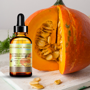 The bottle of organic pumpkin seed oil is placed next to the pumpkin