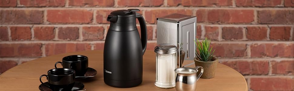 black carafe on wooden table with coffee cup