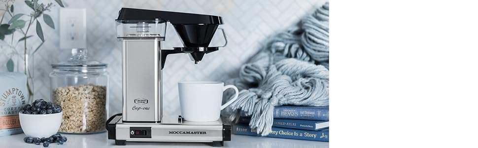 The Moccamaster Cup-One coffee brewer sitting on a kitchen counter.