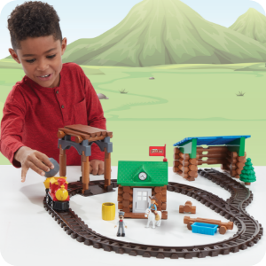 lifestyle image of boy playing with train set