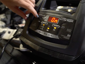 Car battery charger with battery and alternator tester for diagnosis of vehicle issues.