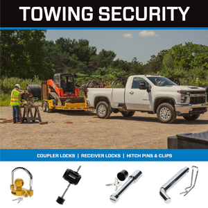 Chevy HD pick up truck coupled to a heavy duty flatbed trailer towing a skid steer