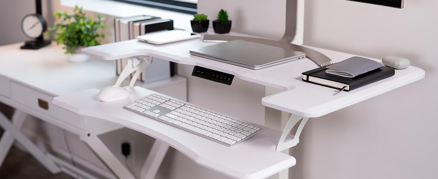 White mobile desk space with laptop, monitor, keyboard