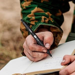 Zebra Stainless Steal Tactical Ballpoint Pen writing in journal by person in military uniform