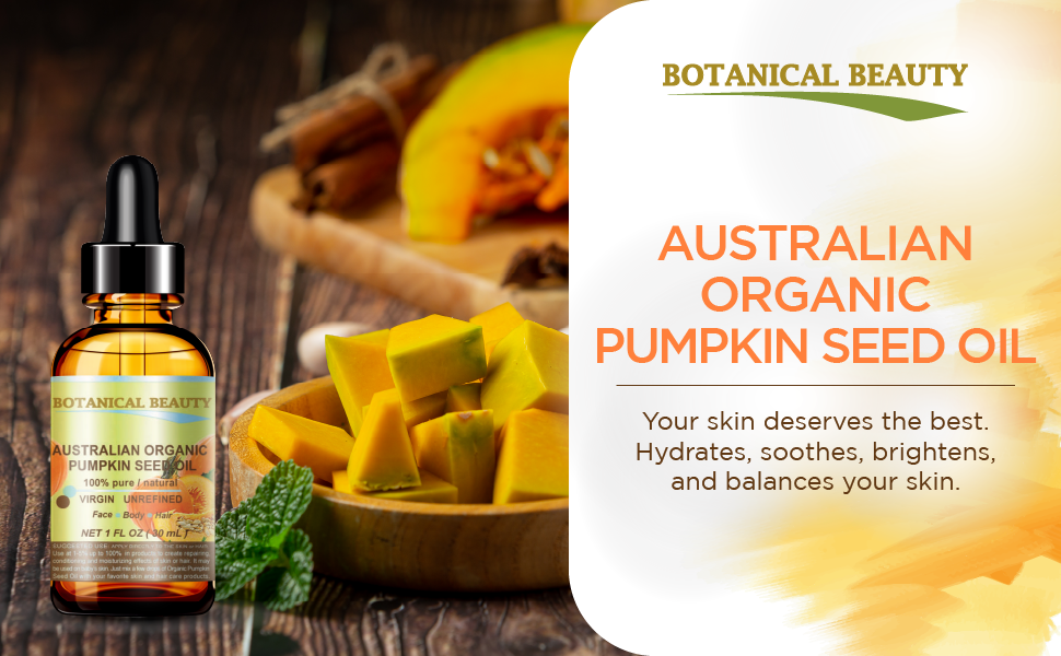 Organic pumpkin seed oil is placed on a wooden table next to a bowl of pumpkin.