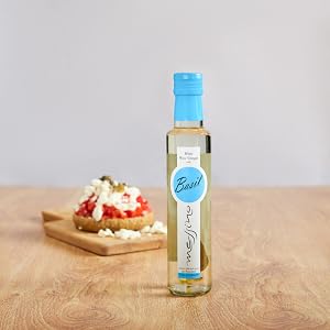 Messino White Wine Vinegar with Basil bottle next to bruschetta