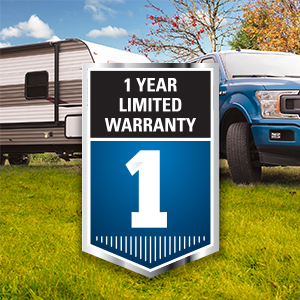 Blue ford f-150 pickup truck towing a RV travel trailer with a shield icon in front