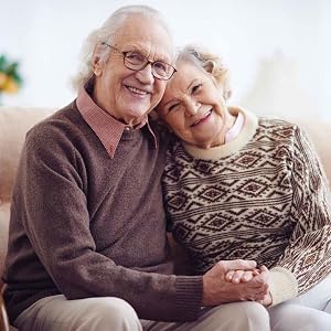 Elderly couple holding hands and smiling