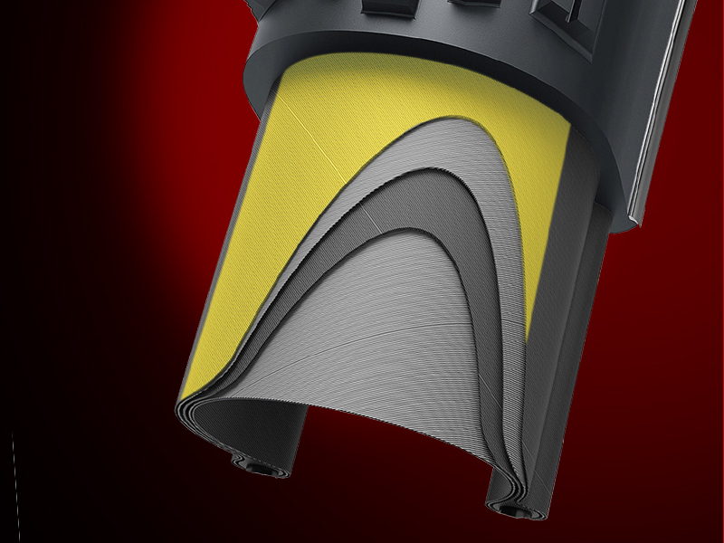 Close-up of a yellow and gray sectioned rubber or silicone product tip, possibly part of a tool or device, against a red background.