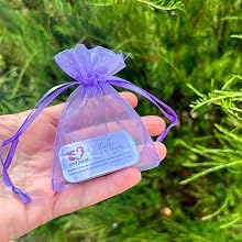Holding a Love from SB Lilac Solid Perfume in an organza bag