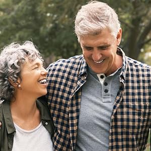 Elderly couple laughing in the park