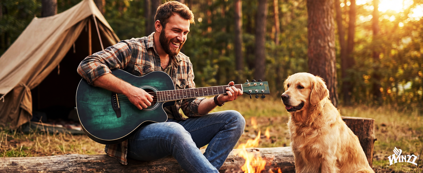Man with beard playing acoustic guitar outdoors near tent, with golden retriever dog sitting beside him in natural camping setting with trees and sunlight.