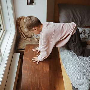 Kinderfeets kinderboard balance board natural wood upside down child pressing on it wood floor