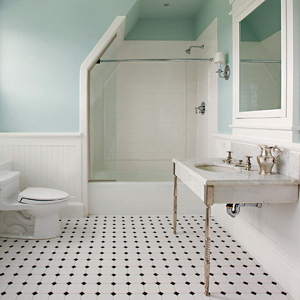 Ceramic tile flooring is shown in a bathroom with white fixtures and green walls
