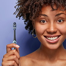 Woman smiling with toothbrush