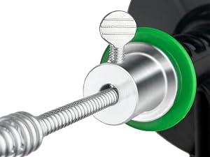 Close-up of a metal fastening mechanism with silver threaded screw, washer, and green rubber gasket or seal component.
