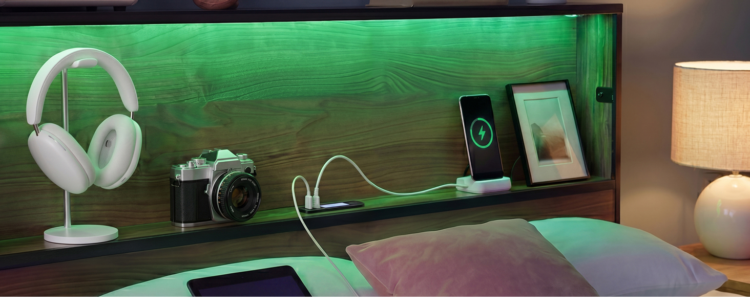 Zinus Kai headboard with green RGB lighting cable plugged in and items on the two tier shelf