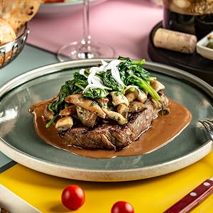 Steak with mushrooms and onion on a plate with gravy