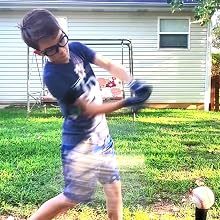 youth baseball player demonstrating swingrail swing trainer