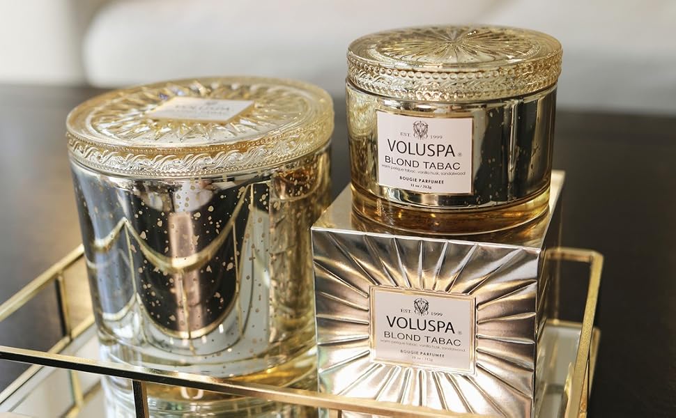Blond Tabac Grande &amp;amp; Corta Maison Candles on a glass tray in front of a couch