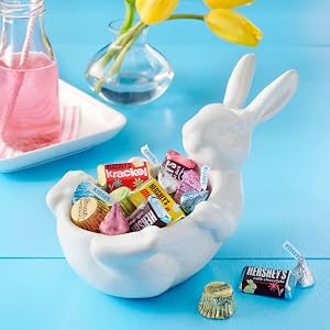 A bunny themed Easter candy dish filled with pastel HERSHEY'S KISSES chocolate candy