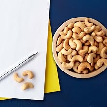 cashews and pen on blue background