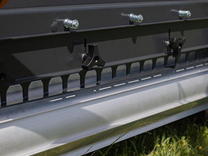 Mini skid steer paired with a manure spreader for tractors and ATVs