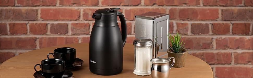 black carafe on wooden table with coffee cup