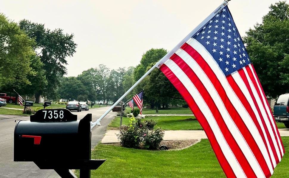 American flag off of the mailboxes of neighbors in suburban neighborhood.