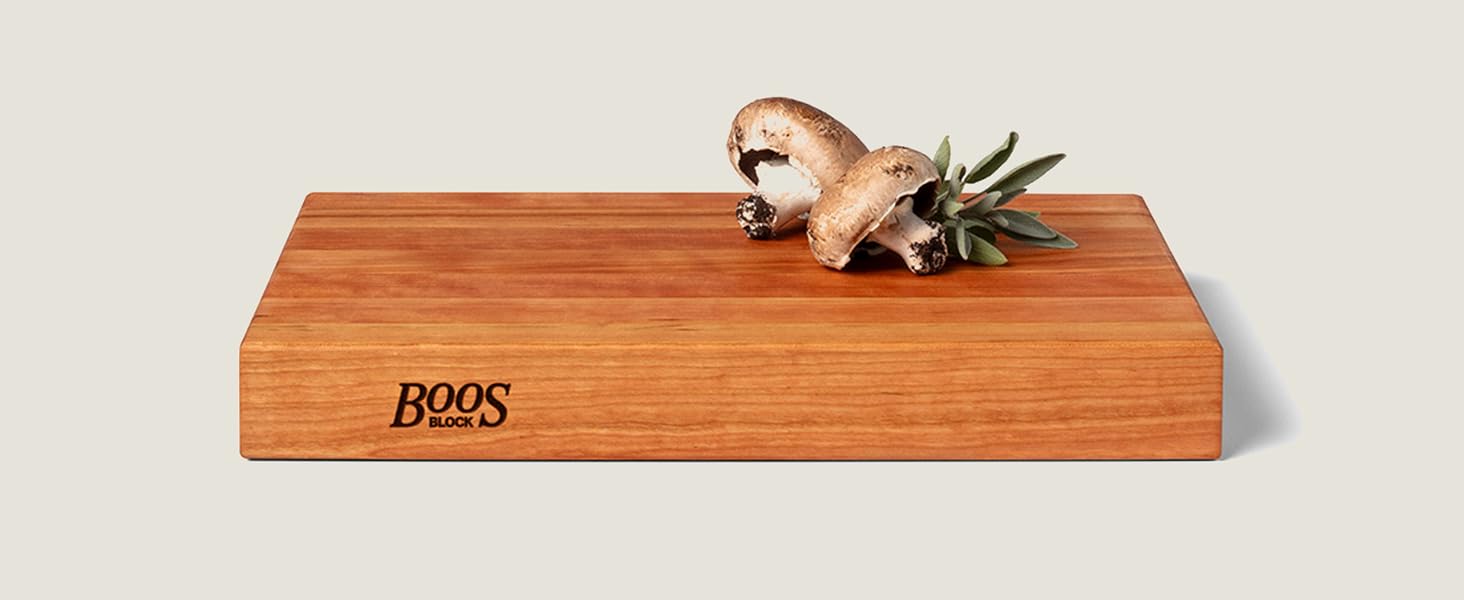 Wood cutting board with fresh mushrooms placed on top, showcasing smooth finish and rich grain.