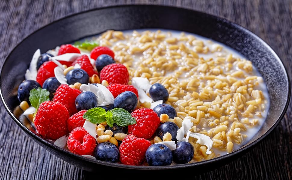 whole oat groats in bowl with berries and milk