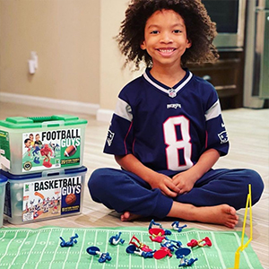 kid playing with football players wearing patriots football jersey