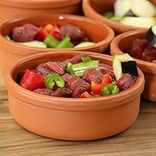 Mexican clay cookware set with terracotta pots, bowls and serving dishes for diverse cuisines.