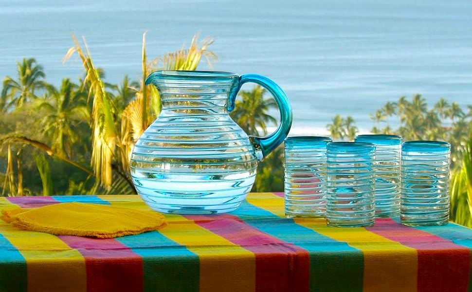 Aqua Blue Spiral Pitcher &amp; 14 oz Drinking Glasses on a colored table setting with an ocean view