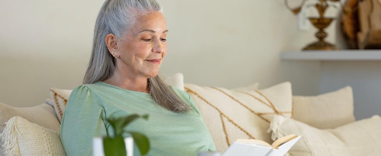 Woman reading a book with the text: &amp;#34;Live fully. Enjoy every page.&amp;#34; for healthy vision.