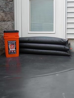 Quick Dam Bucket Kit next to door with jumbo Flood Bags