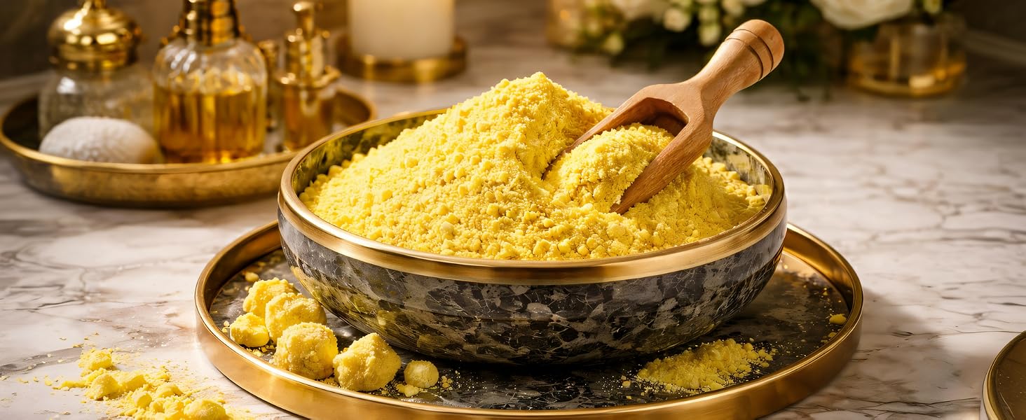 Fine bright yellow sulfur powder in a luxury marble bowl with a wooden scoop on a gold tray