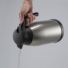 hand holding a carafe and pouring water