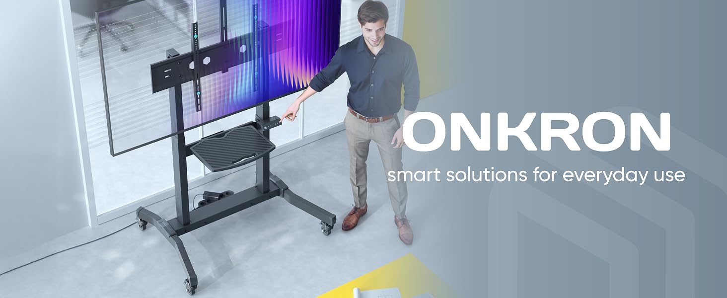 Text reads 'ONKRON'. Modern office setup showing monitor mount installation or adjustment demonstration in an office environment with white walls and natural lighting.