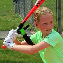 girl softball player demonstrating swingrail swing trainer
