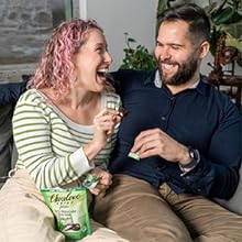 Couple sitting on couch eating Chocolove mint bites