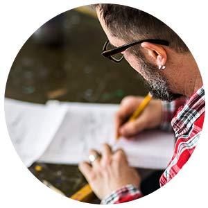 man writing the inside verse of a card