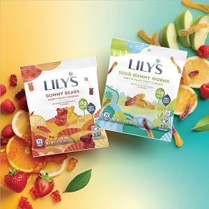 Bags of Lily's gummy bears and Lily's sour gummy worms on a background of sliced fruit