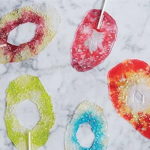 Melted Jolly Rancher hard candy lollipop sticks on a counter top