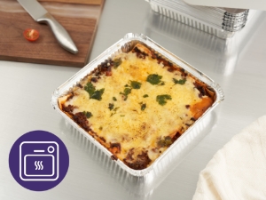 A baked casserole dish with melted cheese topping and dark spots, served in a white rectangular baking dish.