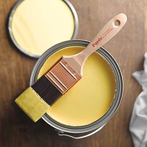 purdy wall paint brush balanced on yellow paint can