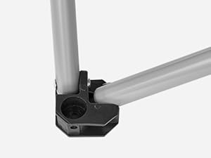Black metal joint connector for tubular structures. Hexagonal shape with screw holes for securing perpendicular tubes.