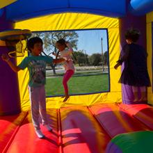 Kids Bouncing in a Hero Kiddo Bounce Castle