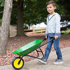 kid hauling wheelbarrow around the yard