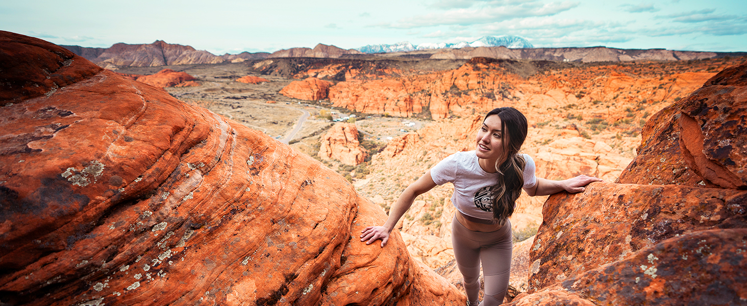 A young woman wearing a Sunwarrior shirt hiking in the southen Utah desert